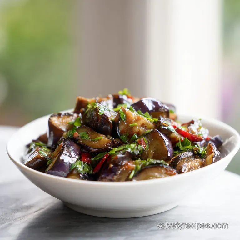Slightly charred, rich purple eggplant strips fanned out on a white plate, drizzled with a dark balsamic glaze.